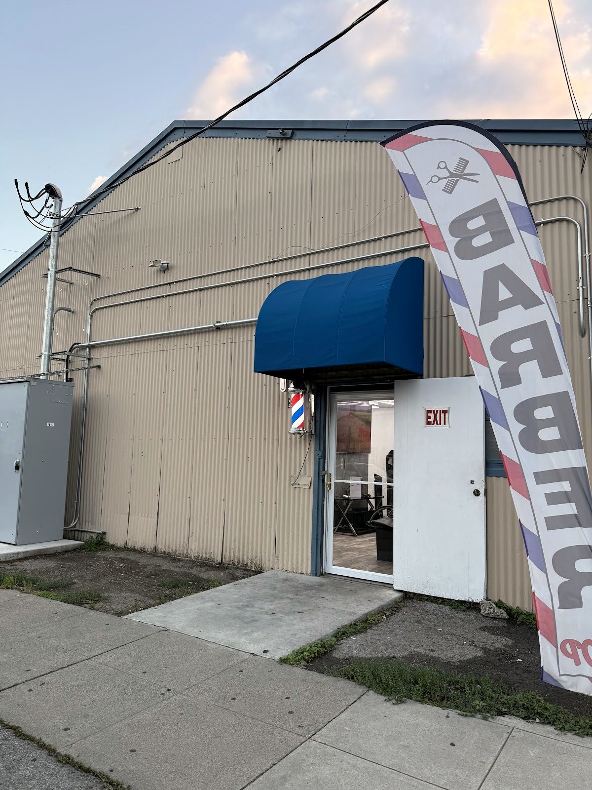 The Angel Barbershop storefront with the blue awning on N 27th St